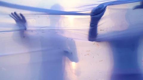 Moving figures of young man and woman behind a white fabric. Concept of barriers Stock Footage 119715997