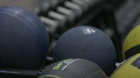 Moving focus from medballs to dumbbells Stock Footage 106588627