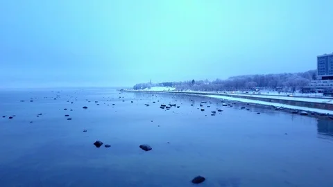 Moving forward aerial shot through smooth winter sea. Misty cold winter sea. Stock Footage 100127913