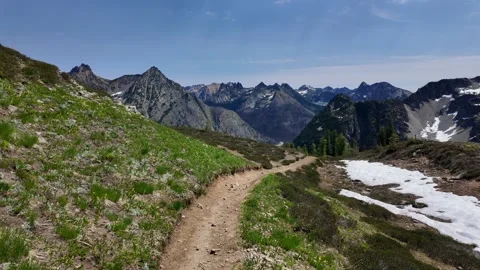 Moving forward along a dirt path with dramatic mountain range in the background Stock Footage 342076350