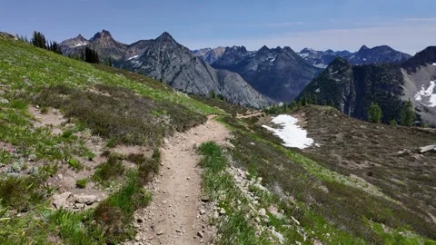 Moving forward along a dirt path with dramatic mountain range in the background Stock Footage 342076360