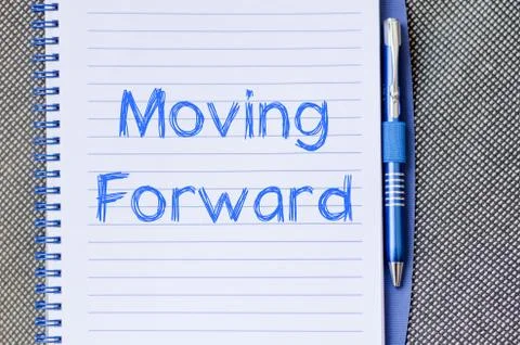 Moving forward concept on notebook Stock Photos