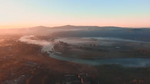 Moving forward to forest and mountain valley in thick fog with sun flare in Stock Footage 125057222