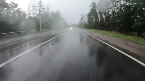 Moving forward on long road amoung trees while heavy rain. Stock Footage 145489922