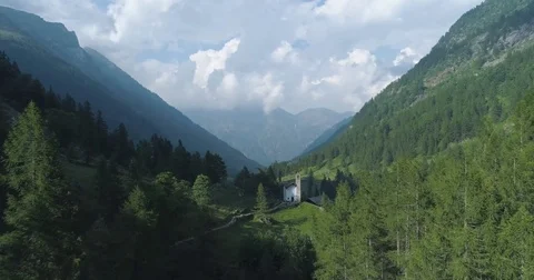 Moving forward to pine woods forest and mountain church in summer day.Europ Stock Footage