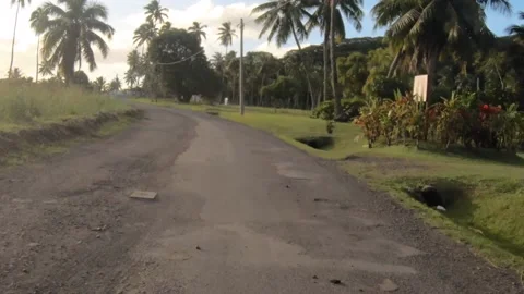 Moving forward riding view at a backroad in tropical Pacific Islands where Polyn Stock Footage 235311364
