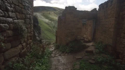 Moving forward through the abandoned mountain village of Gamsutl, Dagestan. Video stock 162815510