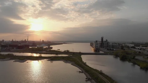 Moving Forward Toward Industrial Harbor At Sunset Passing Several Large Boats Video stock 112581401