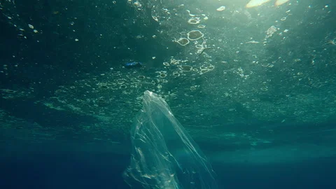 Moving forward, wading through plastic garbage floating under water's surface Stock Footage 339969860