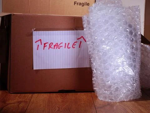 Moving fragile items with cardboard boxes and bubble wrap Stock Illustration
