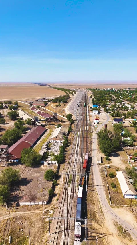 Moving Freight Train Through Large Railway Yard in Dry Steppe Stock Footage 346320709