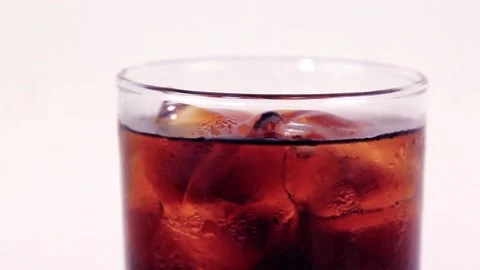 Moving glass of cola with ice is filled with black cola on white background  Stock-Footage 200866517