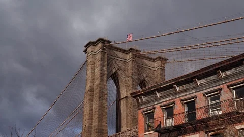 Moving glide shot of iconic Brooklyn Bridge towers over the Hudson River in NYC Stock Footage 122536075