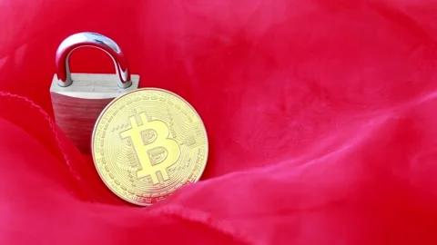 Moving glitter over bitcoin on red background with padlock Stock Footage 133424795