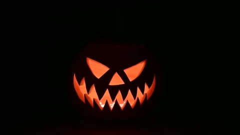 Moving glowing jack-o-lantern lit from inside Stock Footage 313080798