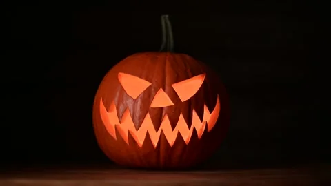 Moving glowing jack-o-lantern lit from inside Video stock 313080845