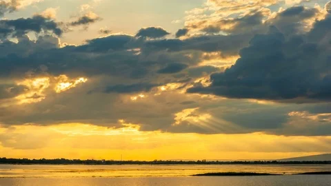 Moving golden clouds at sunset over lake. 4K timelapse Stock Footage 82644068
