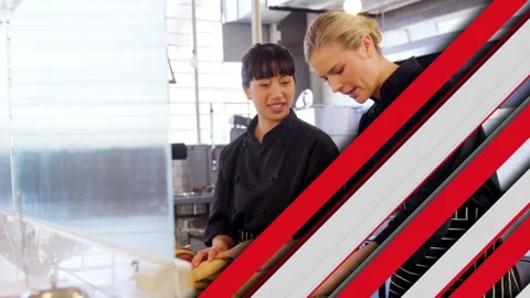 Moving graphic clearing two chefs slicing bread at counter, left chef showing Stock Footage 333233774