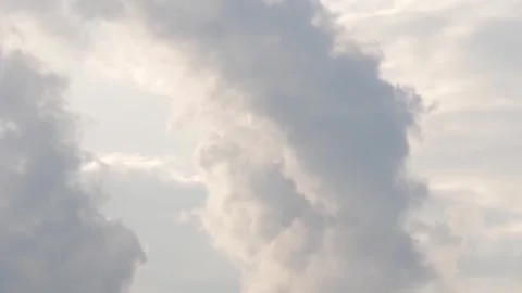 Moving gray fluffy cloud changing shape by wind blow on white cloudy sky Stock Footage 242274122