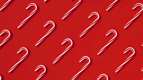 Moving grid of candy canes on red background. Christmas candies. New Year 3d Stock Footage 294549214