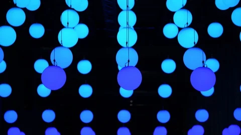 Moving hanging spheres of light changing color, cyan, blue, during night Stock Footage 128400793