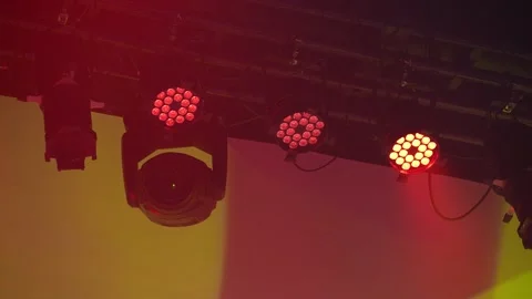 Moving head stage light emitting bright yellow-green beams Stock Footage 346359455