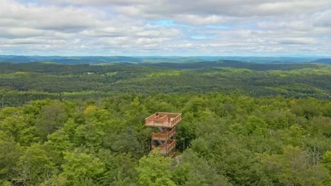 Moving high above, flying away from the watchtower, showing the drone pilote 動画素材 170406534