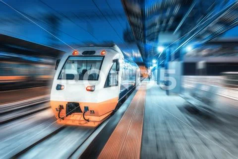 Moving high speed train train on the railway station at night Stock Photos