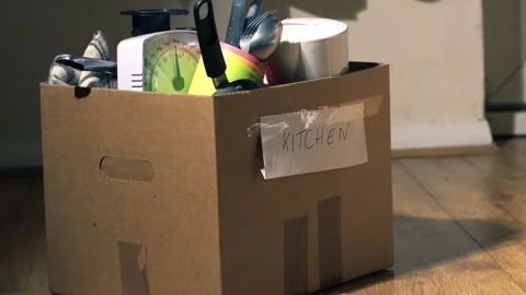 Moving home with cardboard boxes packed with kitchen utensils Stock Footage 243632241