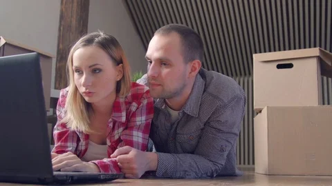 Moving, home, technology and couple concept - smiling couple with laptop sitting Stock Footage 72231402