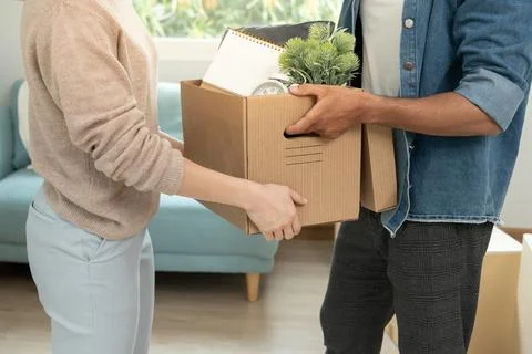 Moving house, relocation. Couple help set and move furniture for new apartm.. Foto stock