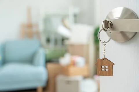 Moving house, relocation. The key was inserted into the door of the new hou.. Фото
