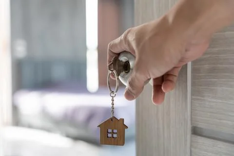 Moving house, relocation. Man open door in new apartment. move in new home... Фото