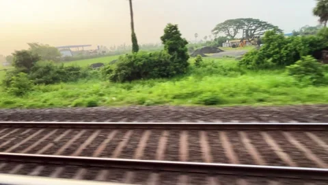Moving Indian Train Passing Parallel Tracks and Green Countryside. Stock Footage 346472675