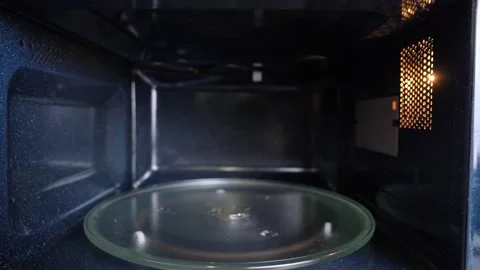 Moving from inside of an empty microwave to outside Stock Footage 231072346