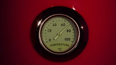 Moving instrument pointer on front side of red vintage temperature meter Stock Footage 223440355