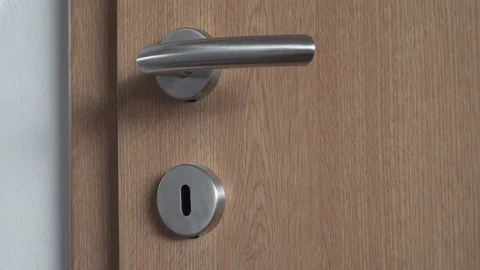 Moving a key in the lock of the door by female hand Stock Footage 84264287