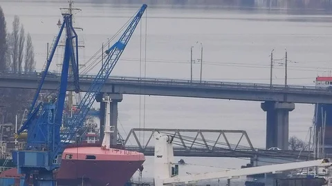 Moving a large construction crane and road traffic on a bridge Stock Footage 105031554