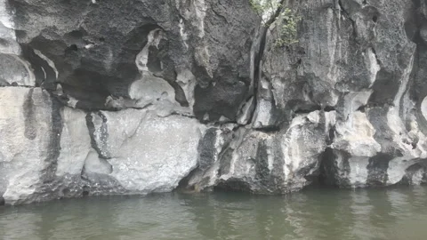 Moving left shot of limestone cliffs beside a river Видео 291208144