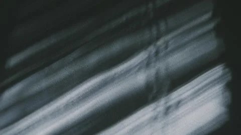 Moving Light and Shadow from Window Blinds on a Textured Wall Stock Footage 318043672