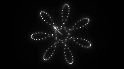 Moving light shapes form a flower pattern on a dark Stock Footage 339329565