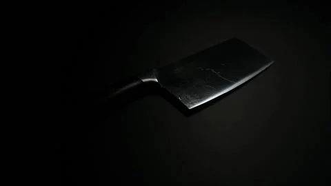 Moving light shining on a cooking knife in the dark Stock Footage 152601505