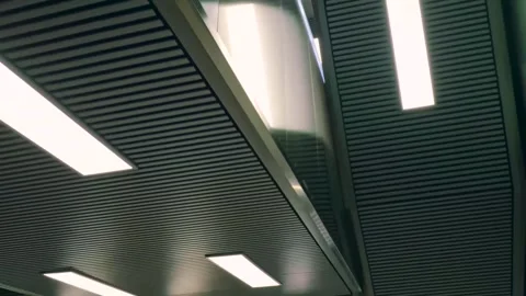 Moving Low Angle Shot of Metro Station Ceiling Lights and Metallic Surfaces Stock Footage 335442265
