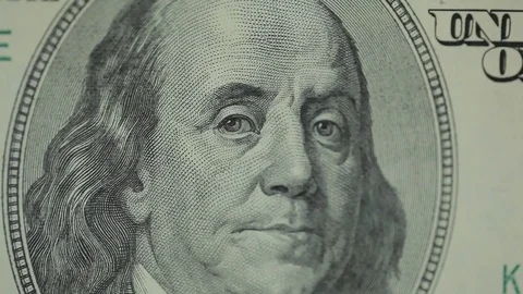Moving macro frame of Benjamine Franklin's face on the US one hundreed dollar Stock-Footage 115325748