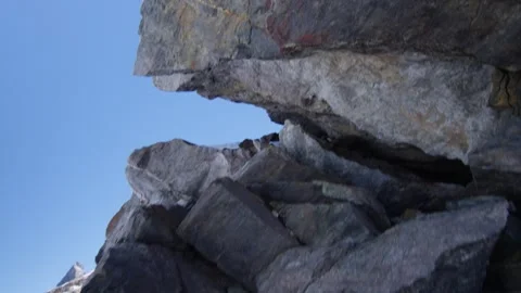 Moving macro shot of snow-covered rocks of an alpine mountain, in France Stock Footage 240415574