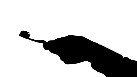 Moving male hands squeezing toothpaste onto a toothbrush Stock Footage 79419172