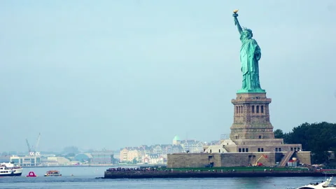 Moving Medium Shot of Statue of Liberty With Boats in Foreground Stock Footage 322049088
