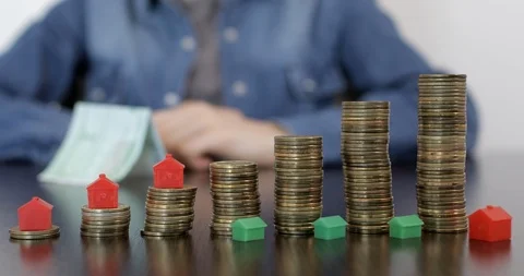 Moving mini model of house on piles of coins. 스톡 동영상 122302444