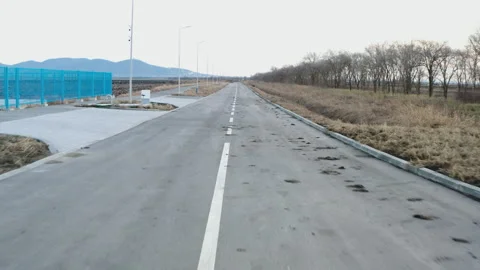 Moving on a muddy asphalt empty road Stockbeeldmateriaal 297105420
