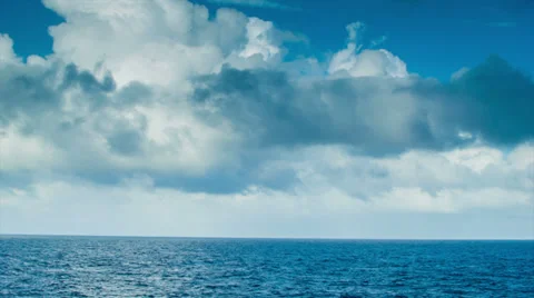 Moving Ocean Scape with Majestic Clouds and Blue Water Stock Footage 36563259